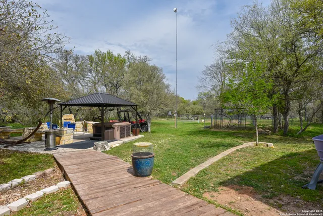a view of a patio with table and chairs under an umbrella