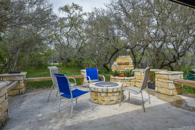 a view of a chairs and tables in the back yard
