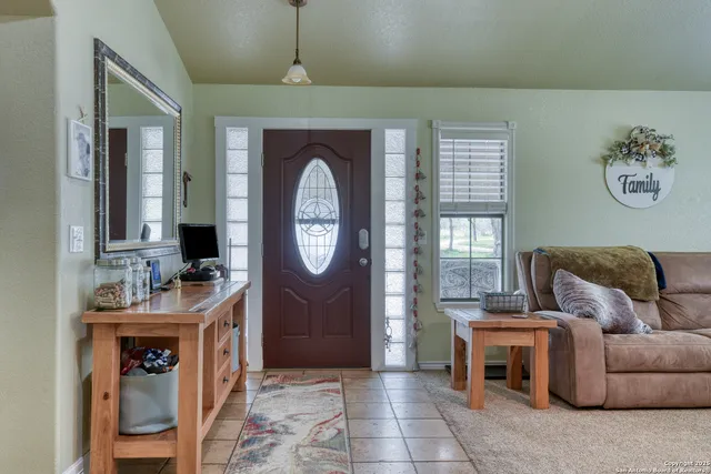 a living room with furniture a clock and a large window