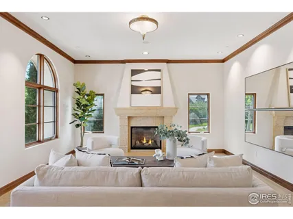 a living room with furniture fireplace and window