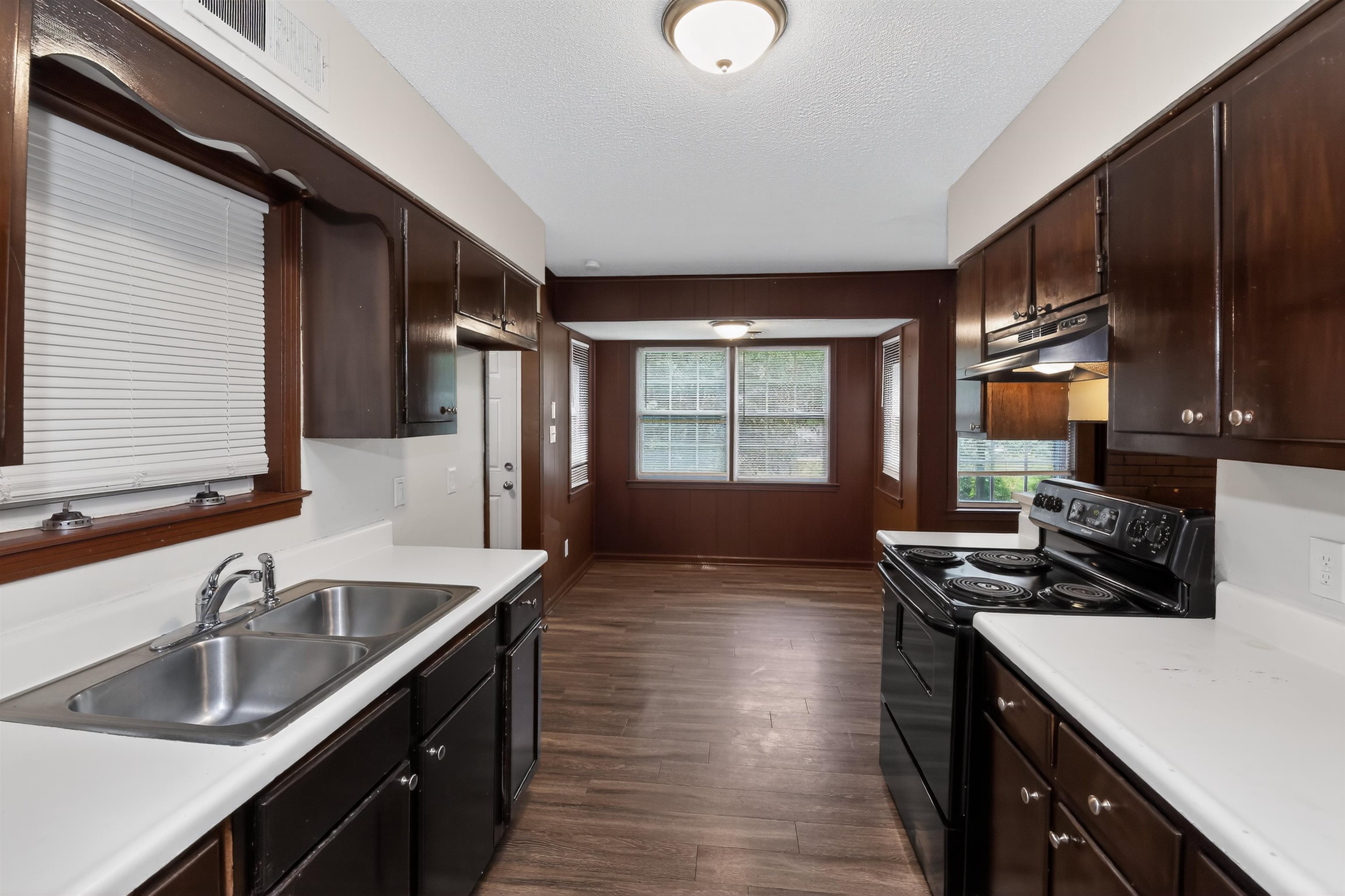 4206 Riche Road Memphis, TN 38128 - Photo 22 of 30 Kitchen featuring dark wood-finish cabinetry, white countertops, and a dual basin stainless steel sink