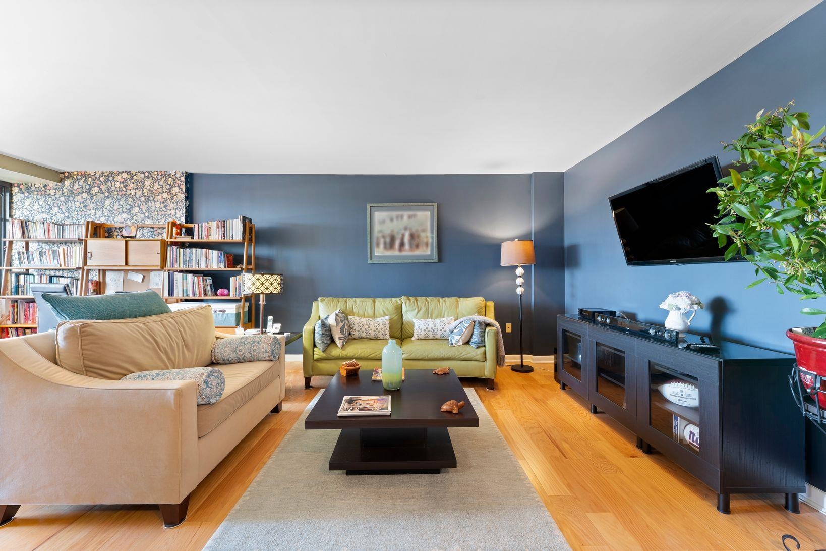 90 Prospect Avenue, Unit 9B Hackensack, NJ 07601 - Photo 2 of 12 a living room with furniture and a flat screen tv