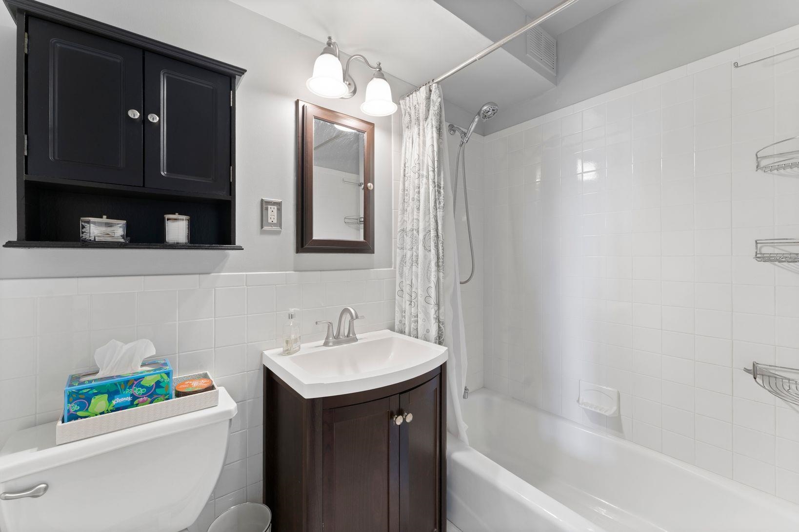 90 Prospect Avenue, Unit 9B Hackensack, NJ 07601 - Photo 8 of 12 a bathroom with a sink a toilet and a bathtub