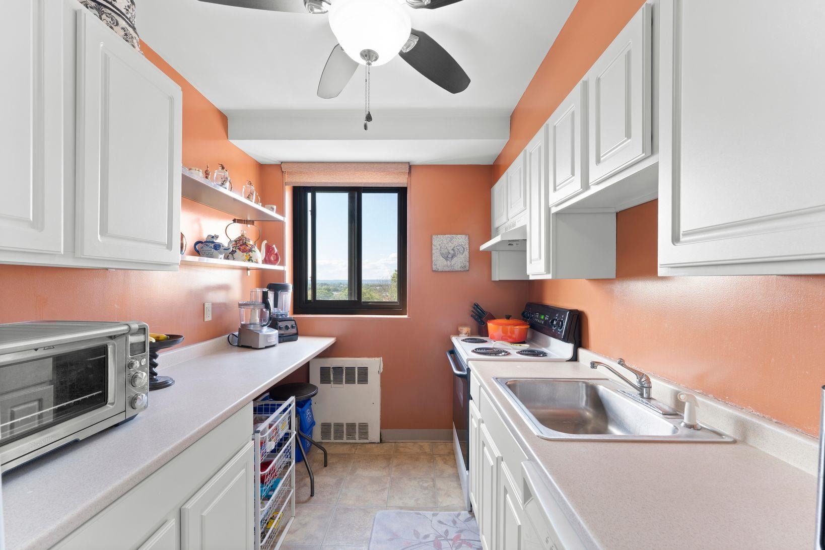 90 Prospect Avenue, Unit 9B Hackensack, NJ 07601 - Photo 9 of 12 a kitchen that has a sink and a stove top oven