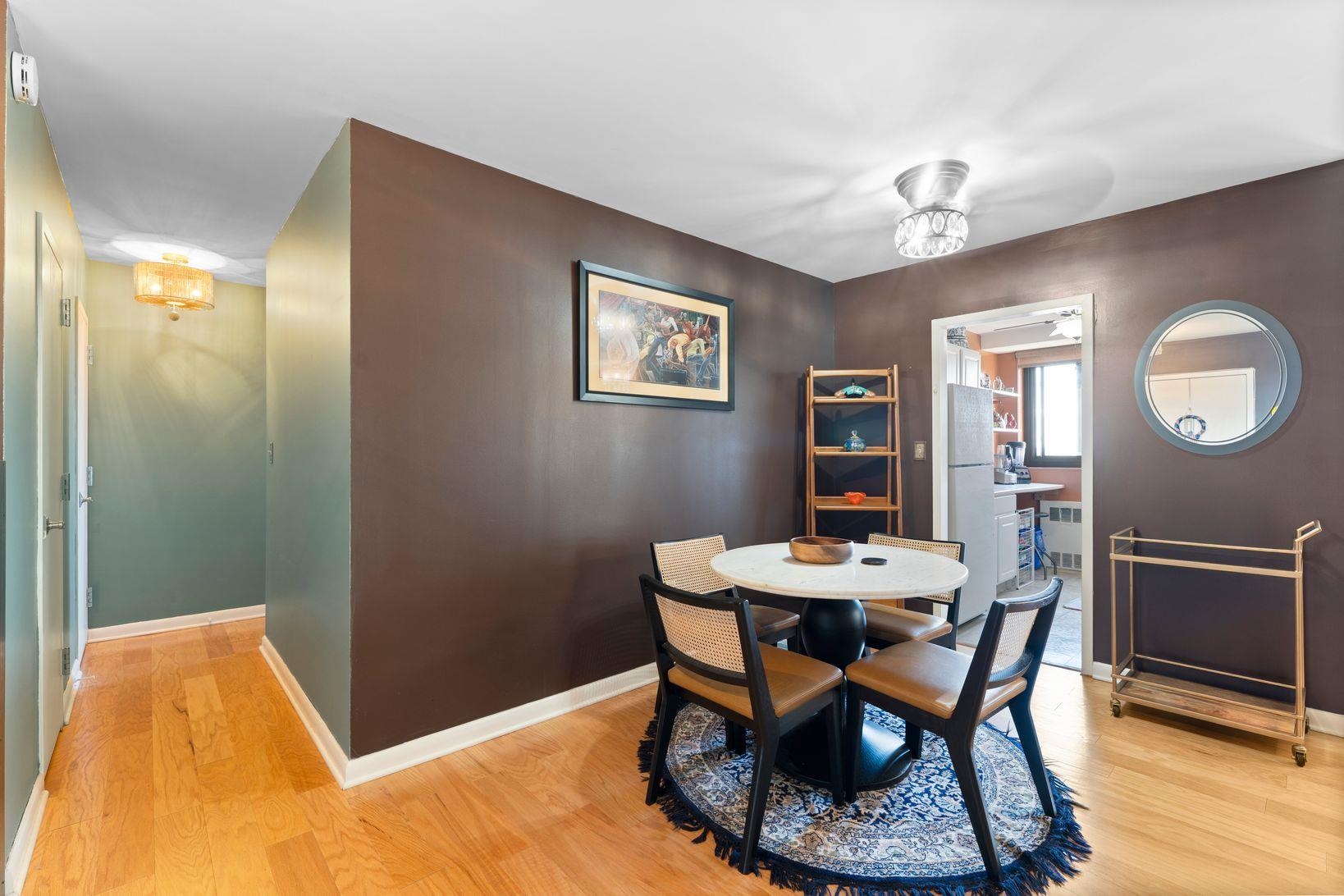 90 Prospect Avenue, Unit 9B Hackensack, NJ 07601 - Photo 10 of 12 a view of a dining room with furniture and wooden floor