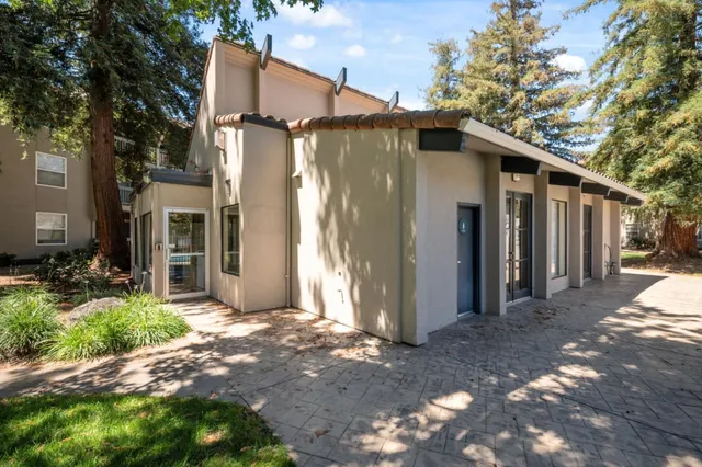 a view of a grey house with a yard