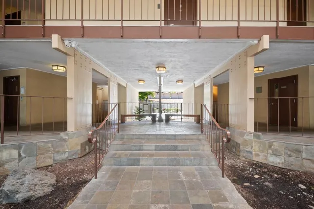 a view of a patio with table and chairs