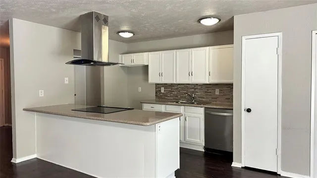 a kitchen with a refrigerator and a stove top oven