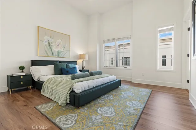 a bedroom with a large bed and a painting on the wall