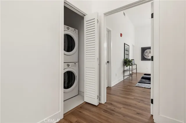 a view of a livingroom with wooden floor and workspace