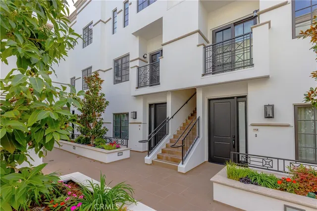 front view of house with a tree in front