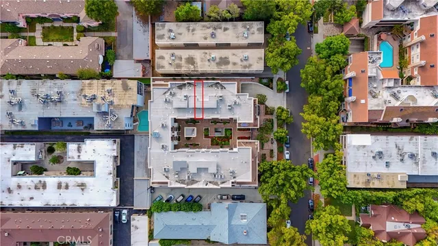 an aerial view of residential houses with city view