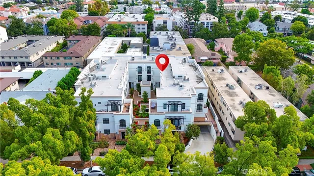 a buildings covered with tall trees