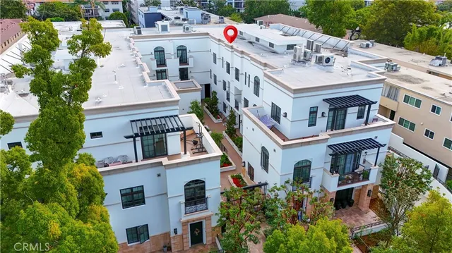 a front view of a house with plants