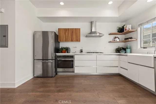 a kitchen with stainless steel appliances a refrigerator sink and cabinets