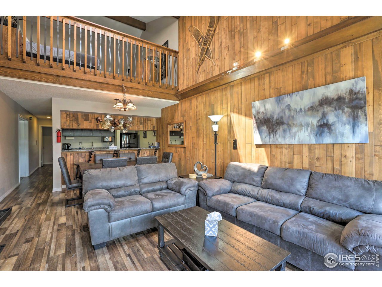 a living room with furniture and a ceiling fan