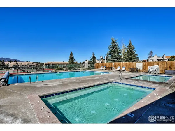 a view of a swimming pool with an outdoor seating