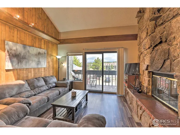 a living room with furniture and a floor to ceiling window