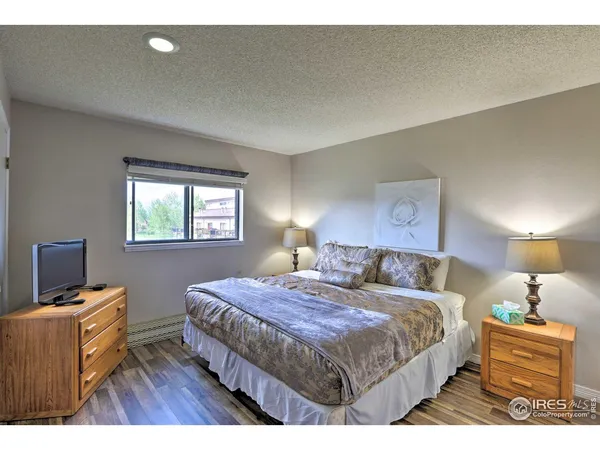 a bedroom with a bed and a tv