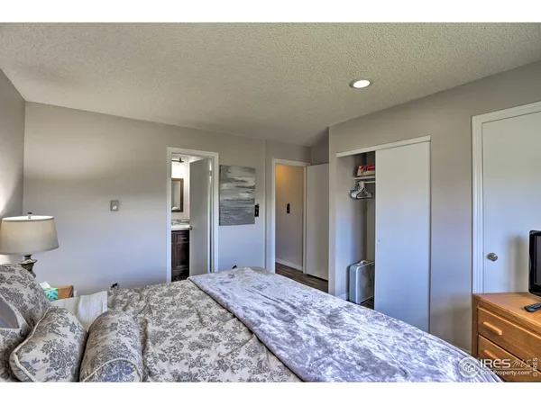 a bedroom with a bed and a lamp