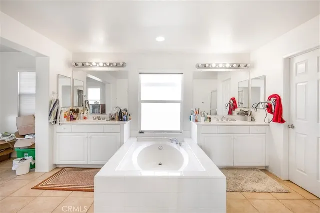 a room with a sink cabinets and window