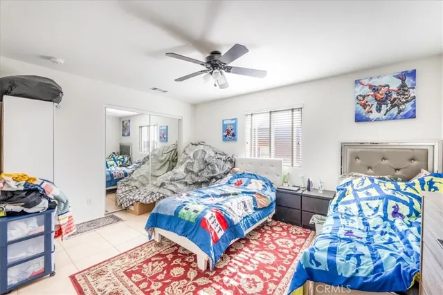 a bedroom with two beds and a window