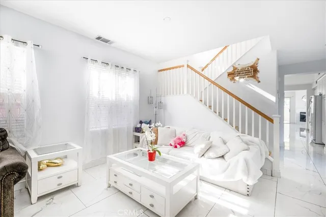 a white bed sitting in a bedroom next to a window