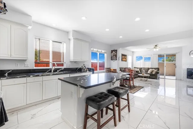 a large kitchen with lots of counter and chairs