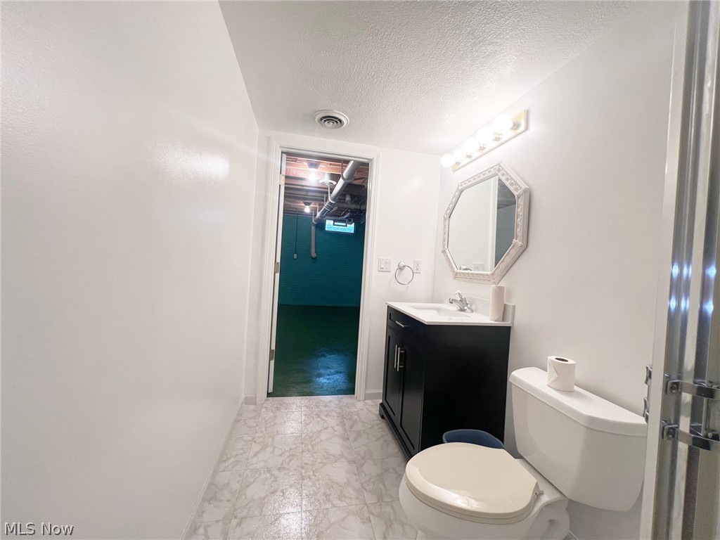 5203 Ridgeland Street Lorain, OH 44055 - Photo 24 of 39 Bathroom with vanity, toilet, tile flooring, and a textured ceiling