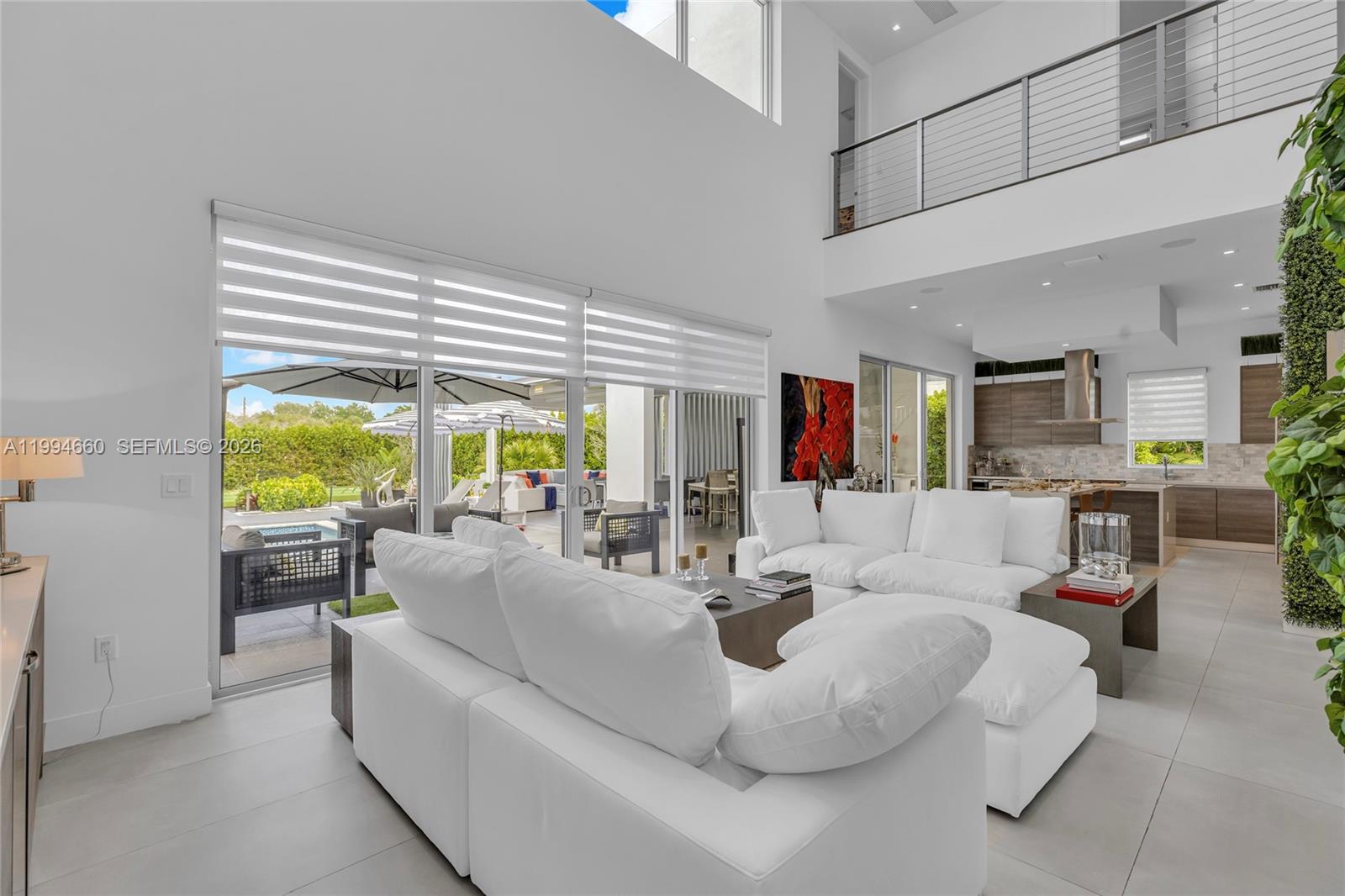 16631 Sunset Way Weston, FL 33326 - Photo 13 of 59 a living room with furniture and a large window