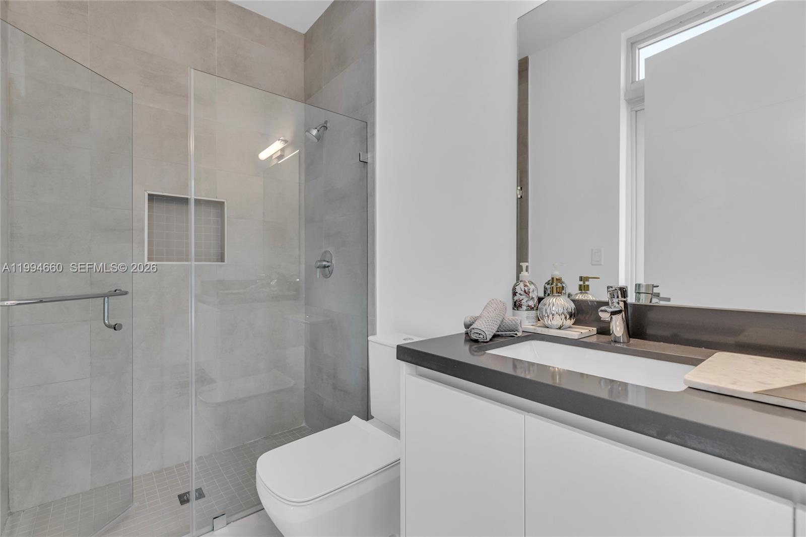 16631 Sunset Way Weston, FL 33326 - Photo 18 of 59 a bathroom with a sink a toilet and shower