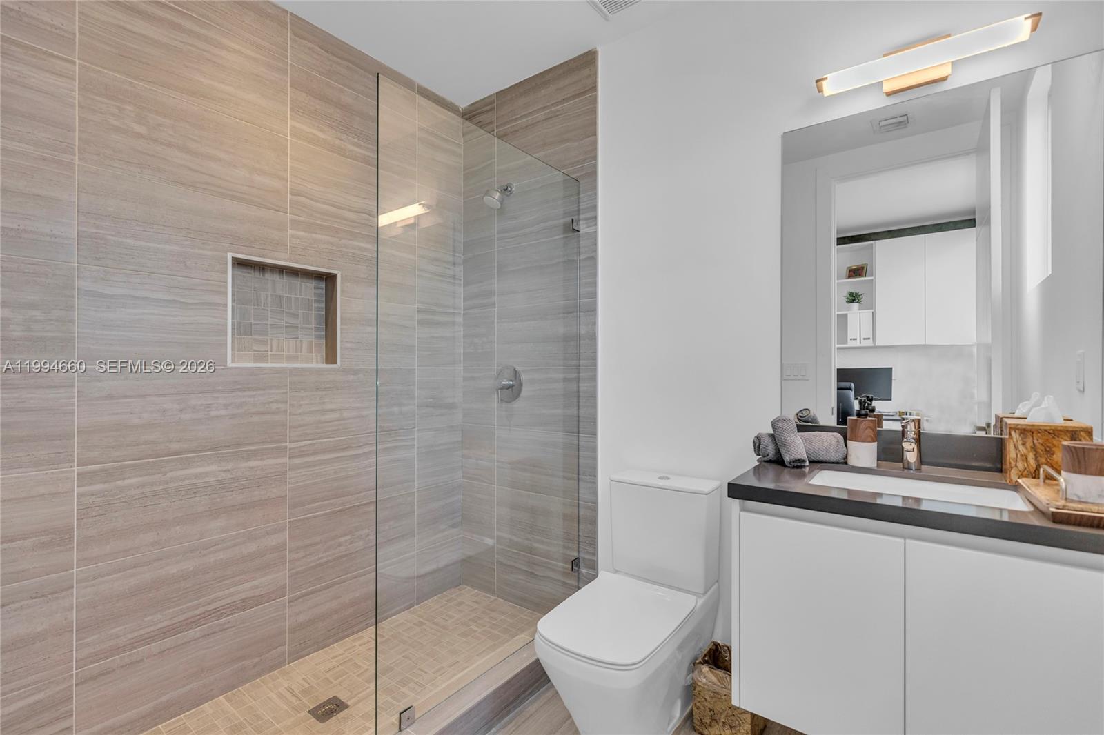 16631 Sunset Way Weston, FL 33326 - Photo 25 of 59 a bathroom with a granite countertop sink toilet and shower