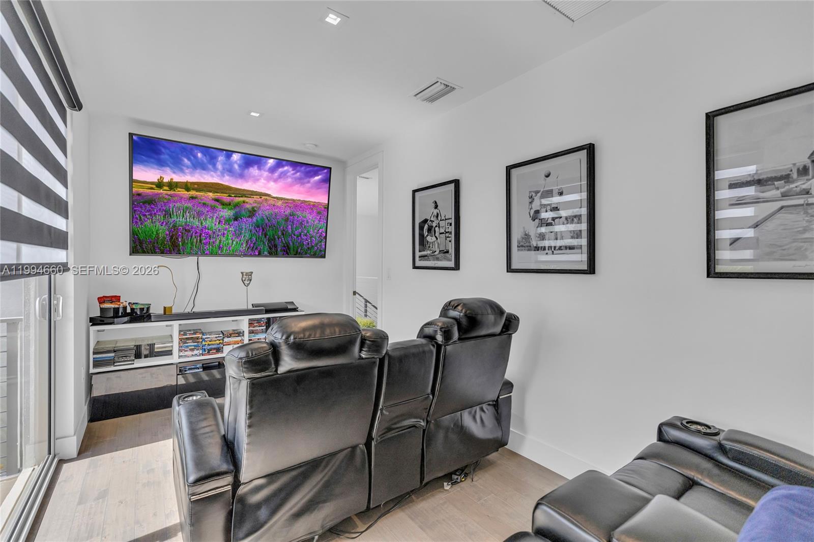 16631 Sunset Way Weston, FL 33326 - Photo 27 of 59 a living room with furniture and a flat screen tv