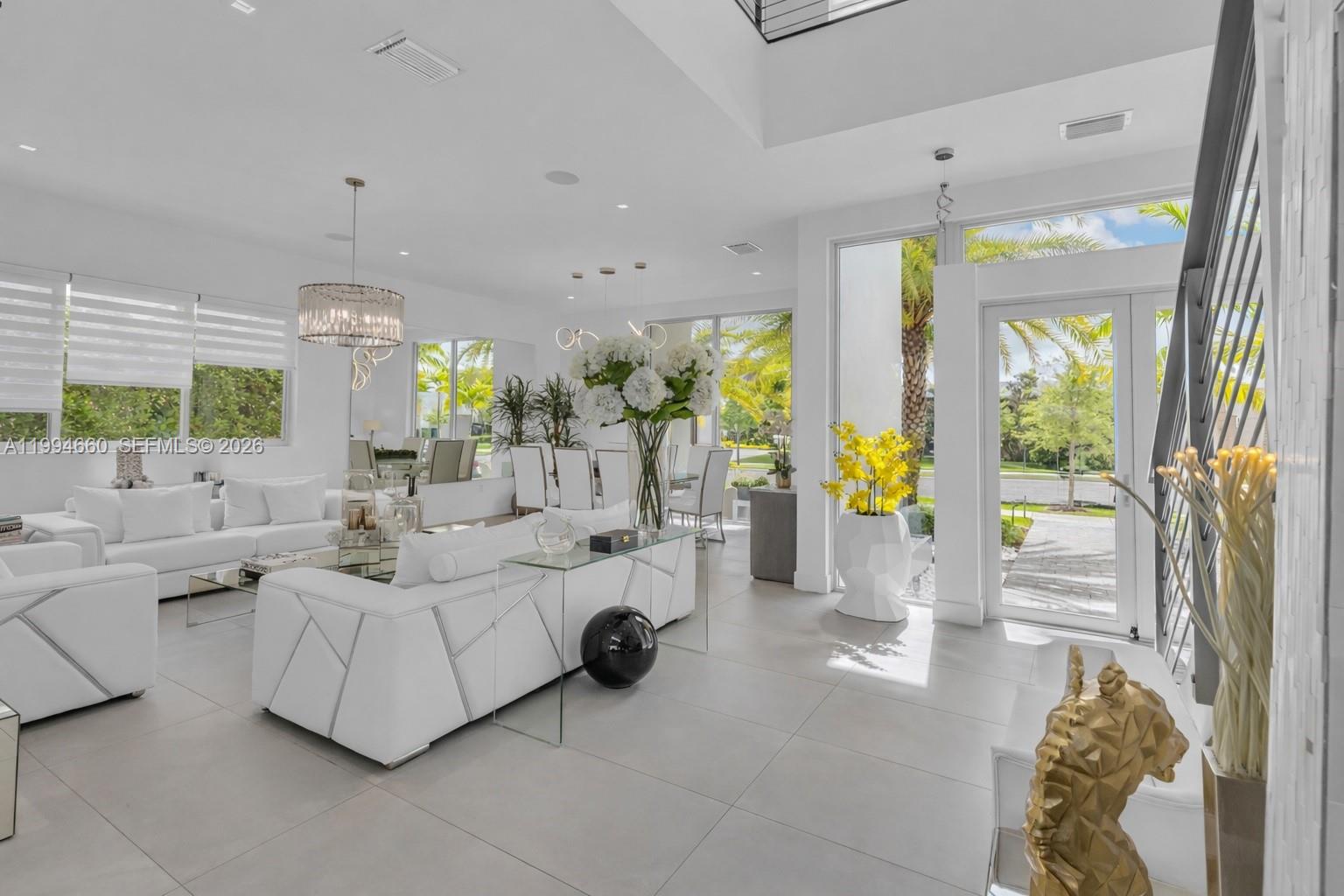 16631 Sunset Way Weston, FL 33326 - Photo 3 of 59 a living room with furniture and a chandelier