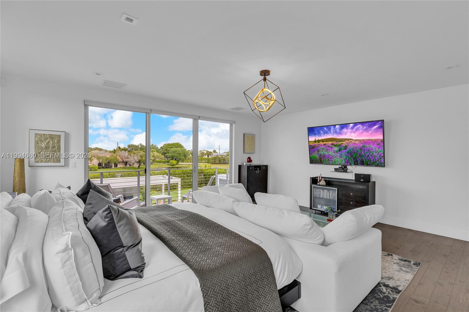 16631 Sunset Way Weston, FL 33326 - Photo 34 of 59 a living room with furniture and a flat screen tv