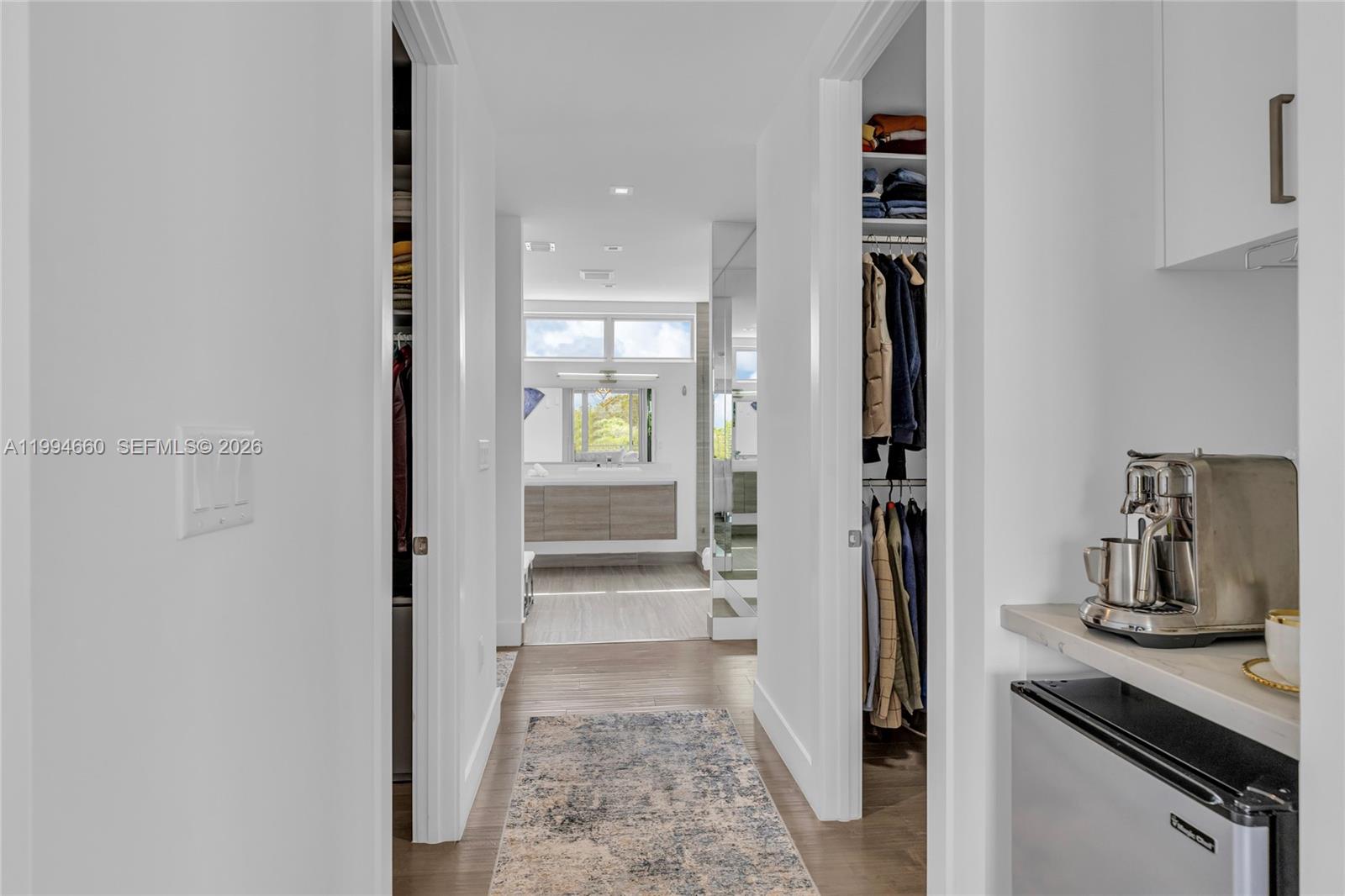 16631 Sunset Way Weston, FL 33326 - Photo 37 of 59 a view of a hallway with wooden floor and a living room