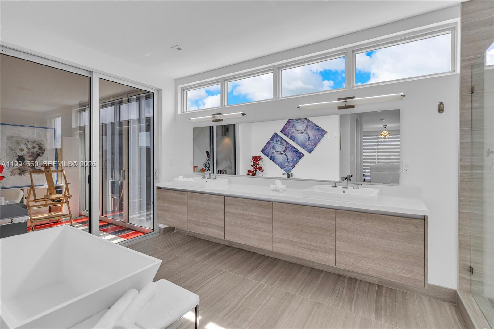 16631 Sunset Way Weston, FL 33326 - Photo 38 of 59 a bathroom with a tub sink and mirror