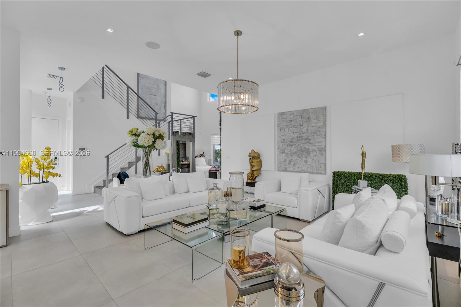 16631 Sunset Way Weston, FL 33326 - Photo 4 of 59 a living room with furniture and a chandelier