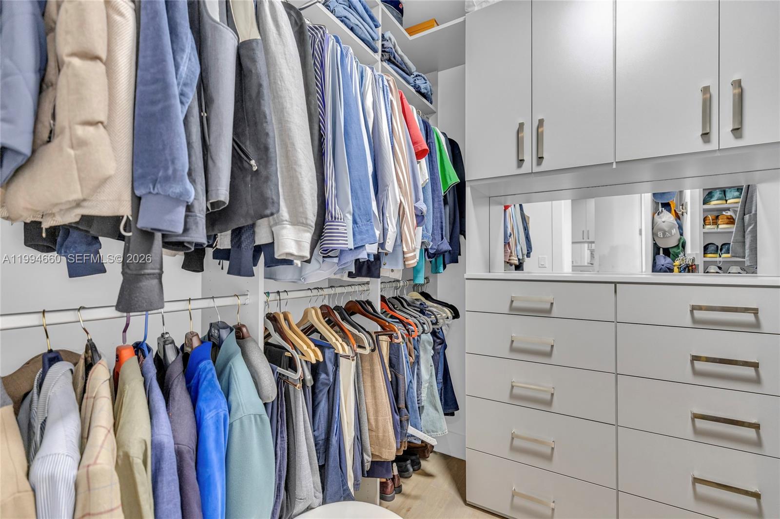 16631 Sunset Way Weston, FL 33326 - Photo 42 of 59 a view of walk in closet with clothes and shoes