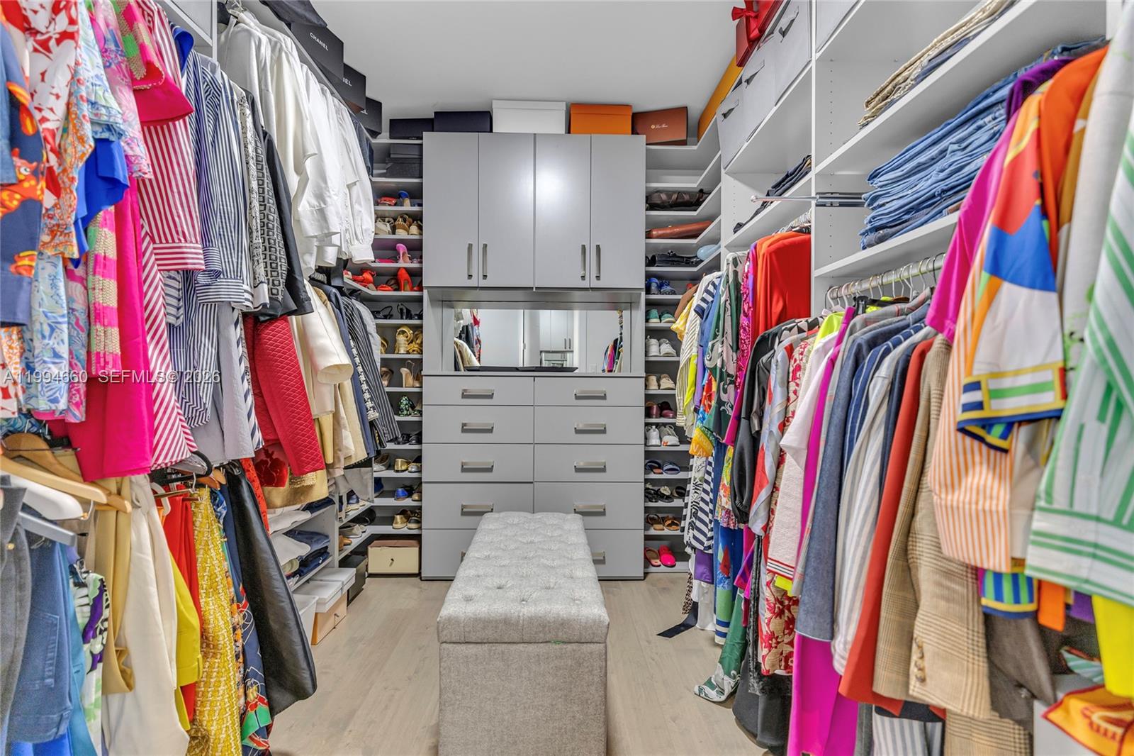 16631 Sunset Way Weston, FL 33326 - Photo 43 of 59 a view of walk in closet with clothes and shoes