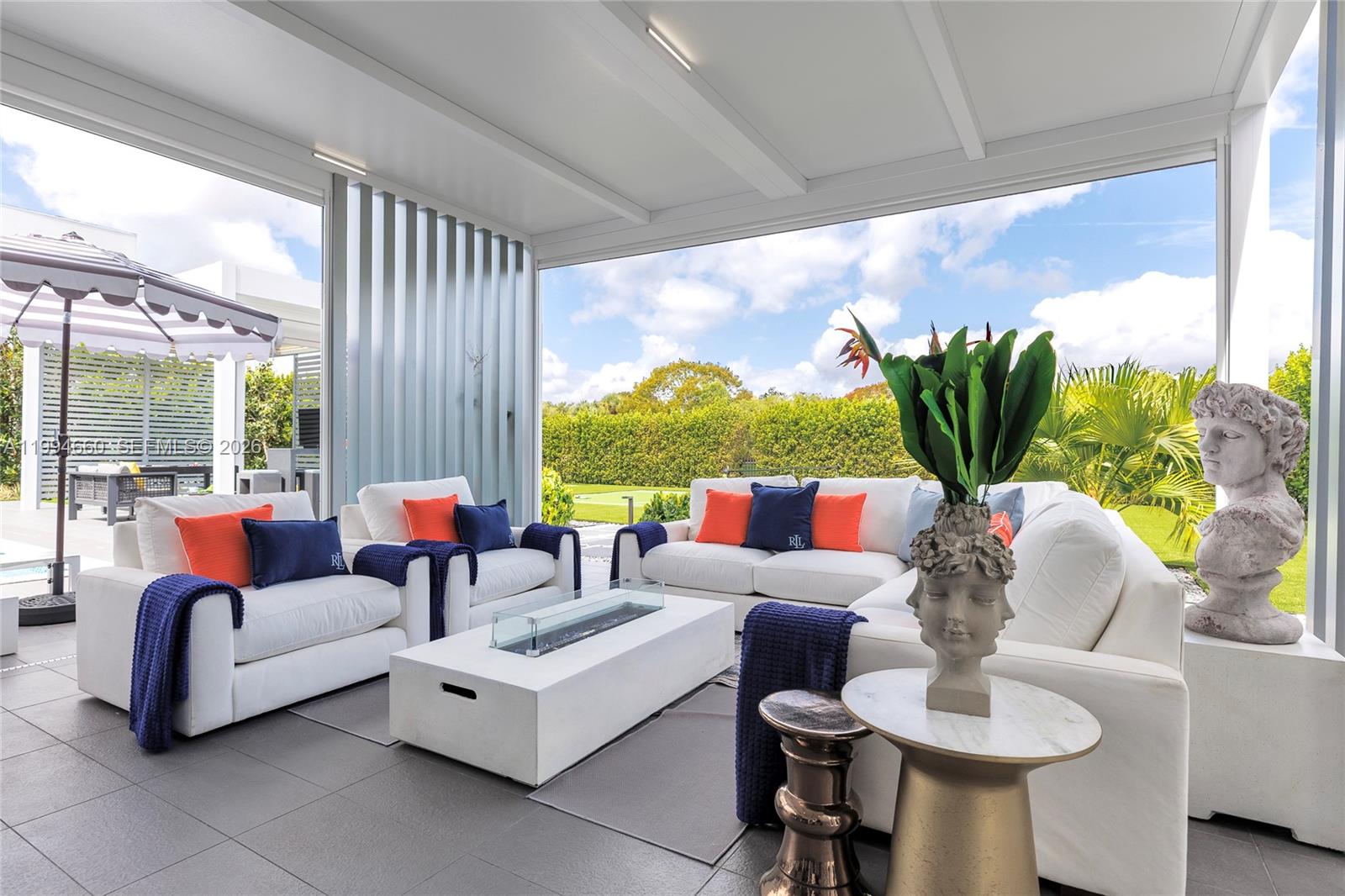 16631 Sunset Way Weston, FL 33326 - Photo 46 of 59 a living room with patio furniture and a large window