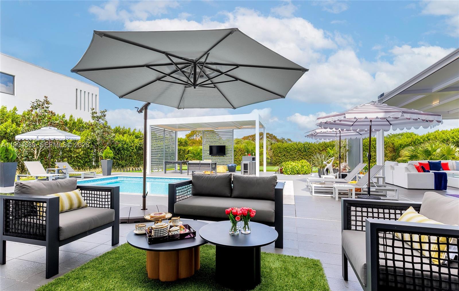 16631 Sunset Way Weston, FL 33326 - Photo 48 of 59 a outdoor space with patio the couches and a umbrella