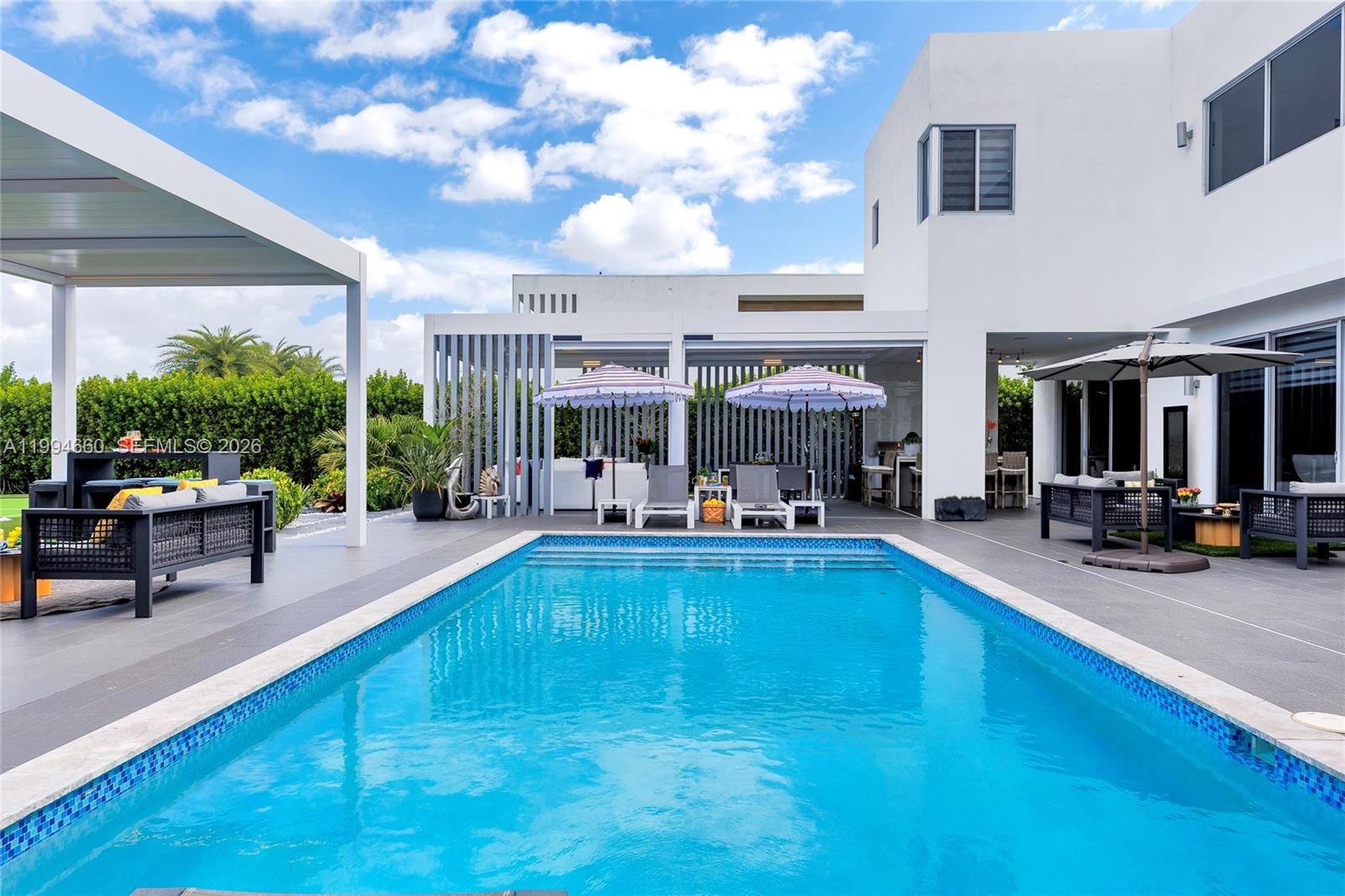 16631 Sunset Way Weston, FL 33326 - Photo 49 of 59 a view of a swimming pool with sitting area