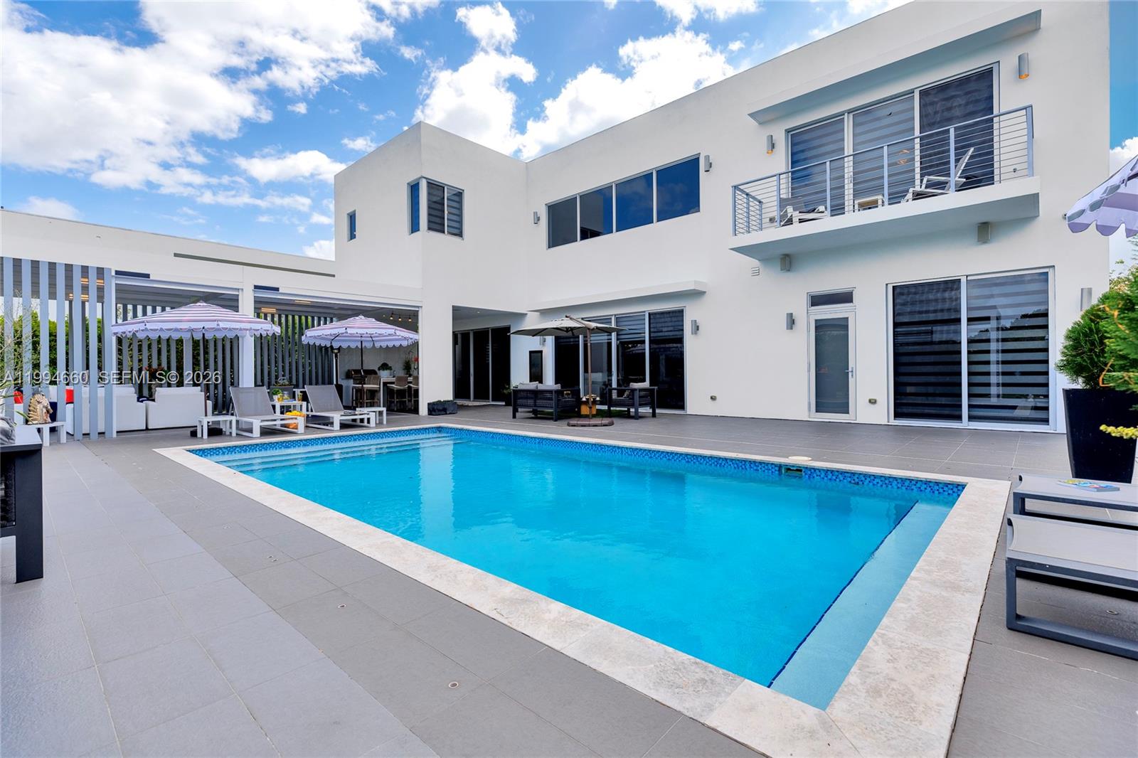 16631 Sunset Way Weston, FL 33326 - Photo 50 of 59 a view of a patio with swimming pool table and chairs
