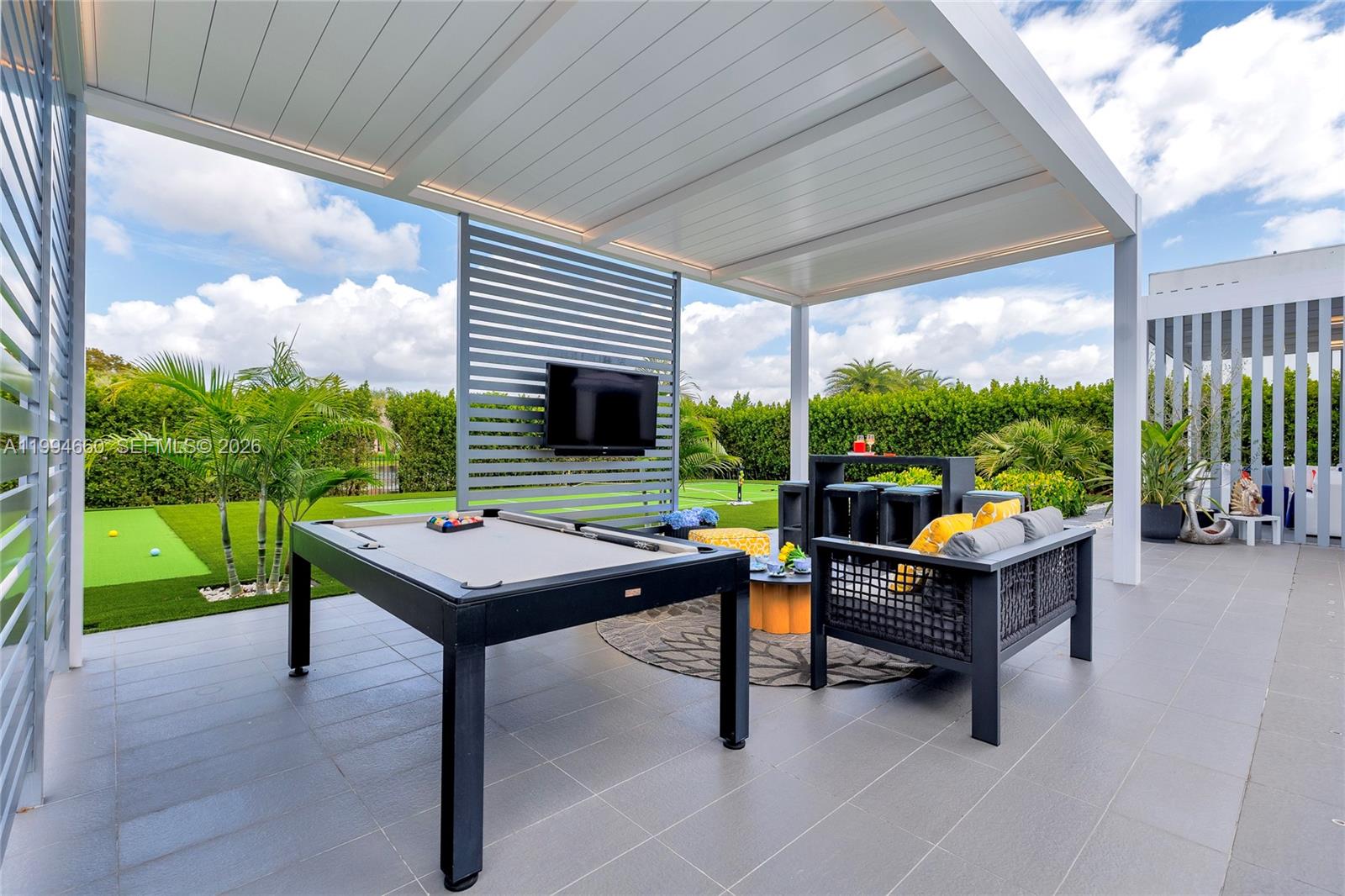 16631 Sunset Way Weston, FL 33326 - Photo 51 of 59 a view of a patio with a table chairs and a backyard