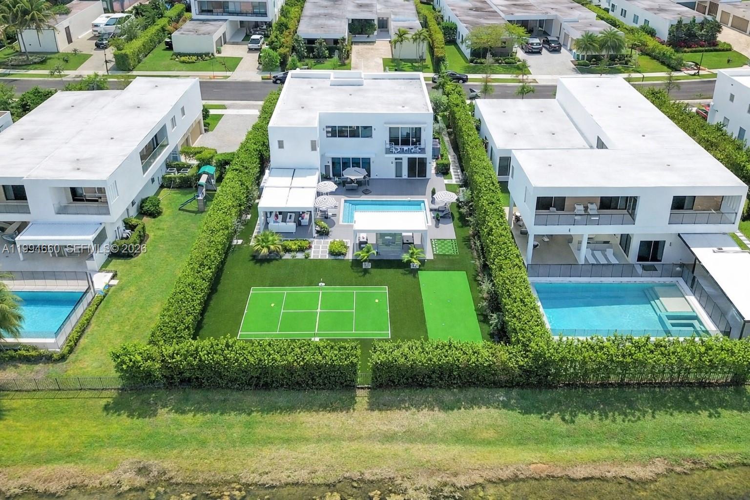 16631 Sunset Way Weston, FL 33326 - Photo 52 of 59 an aerial view of a house with a garden and trees
