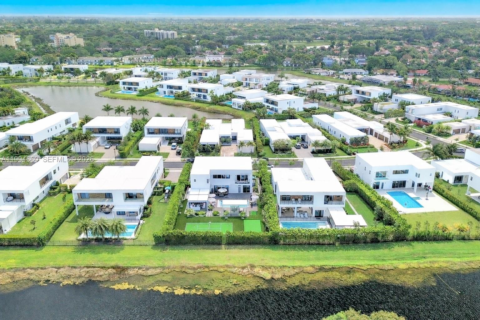 16631 Sunset Way Weston, FL 33326 - Photo 58 of 59 an aerial view of a house with a garden and lake view