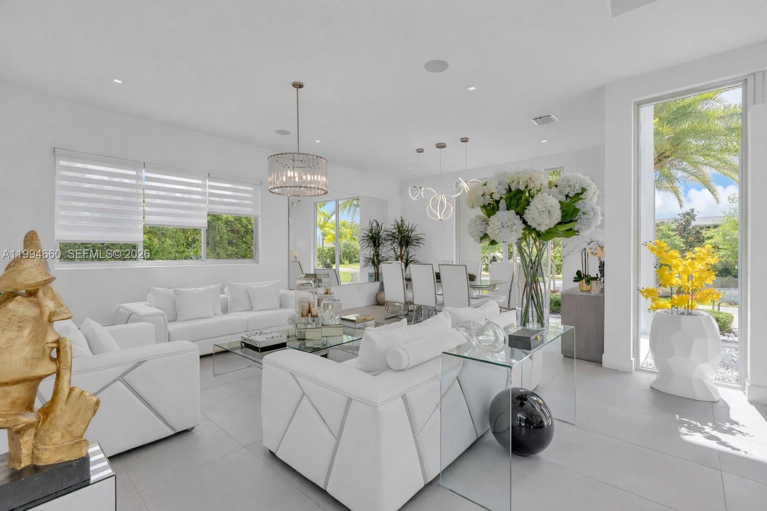 16631 Sunset Way Weston, FL 33326 - Photo 6 of 59 a living room with furniture and a chandelier