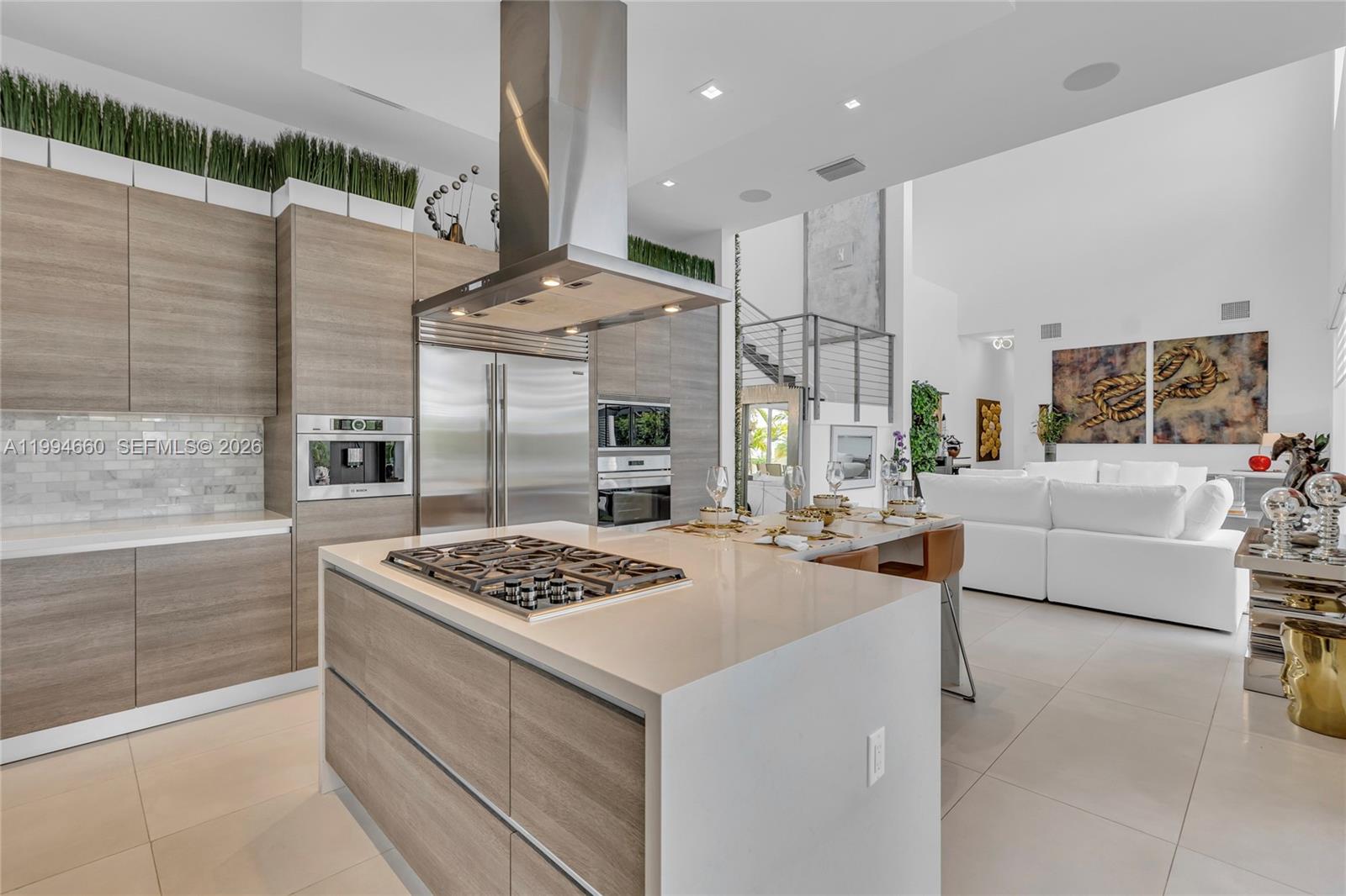 16631 Sunset Way Weston, FL 33326 - Photo 9 of 59 a kitchen with stainless steel appliances kitchen island a stove a sink and a refrigerator