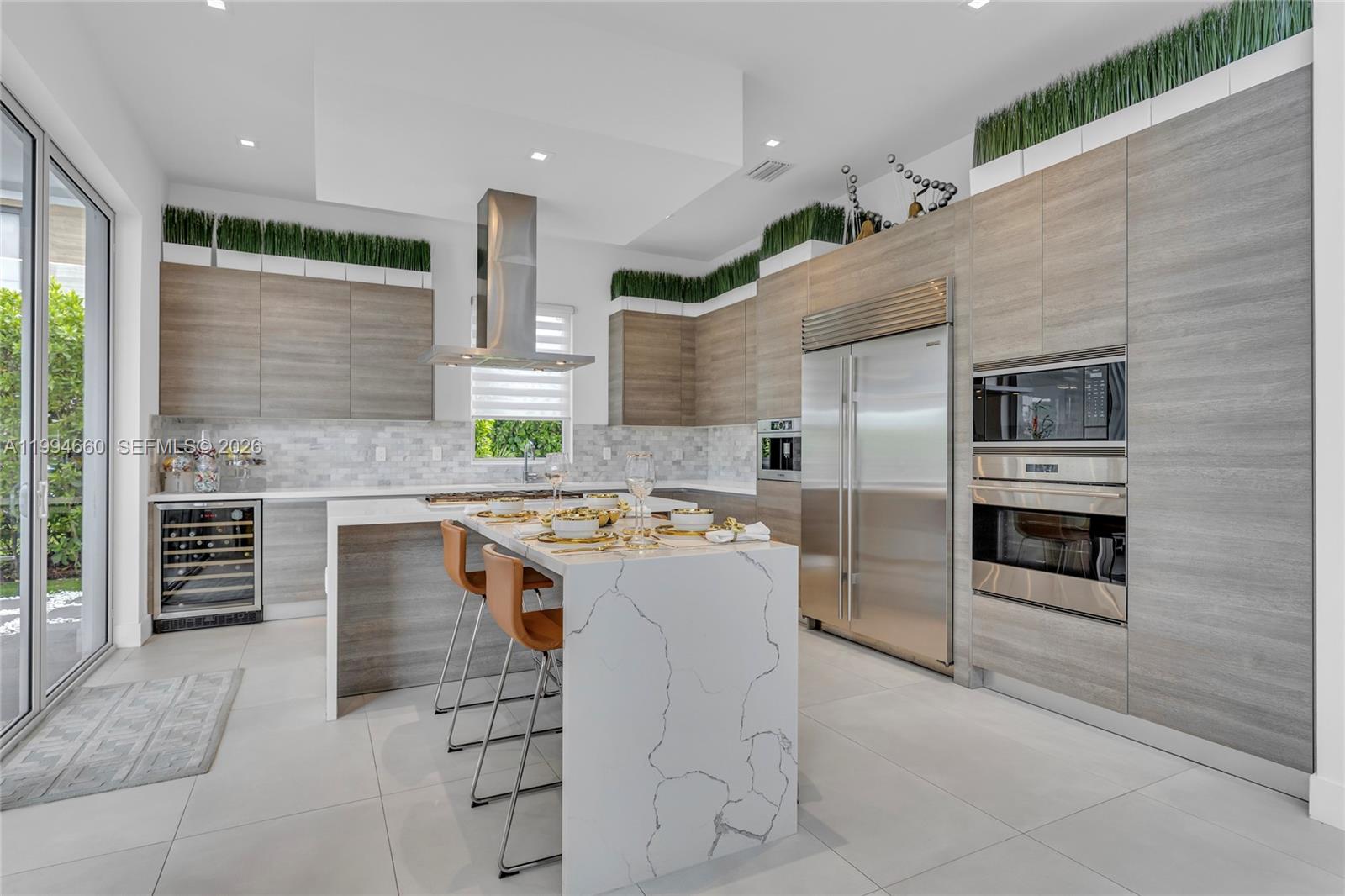 16631 Sunset Way Weston, FL 33326 - Photo 10 of 59 a kitchen with stainless steel appliances granite countertop a stove and more cabinets